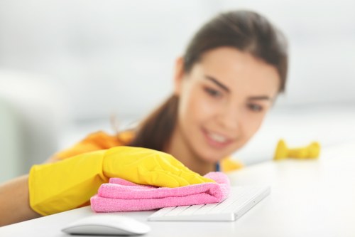 Professional cleaners maintaining floors, desks, and washrooms in a SE16 business property